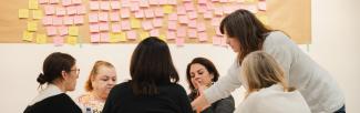 Group photo of THJRC team members brainstorming around a table